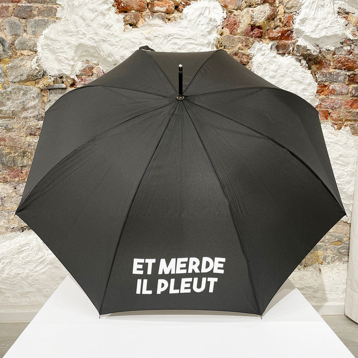 Parapluie avec inscription “Et merde il pleut”